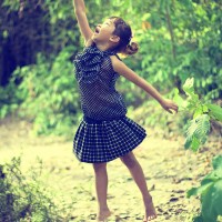Little Girl Reaching Out Tree Branches